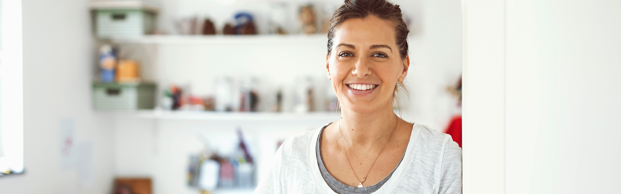 Smiling woman leaning shoulder against wall
